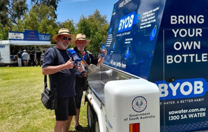 Elderly couple filling up reusable water bottles at an SA Water quench bench